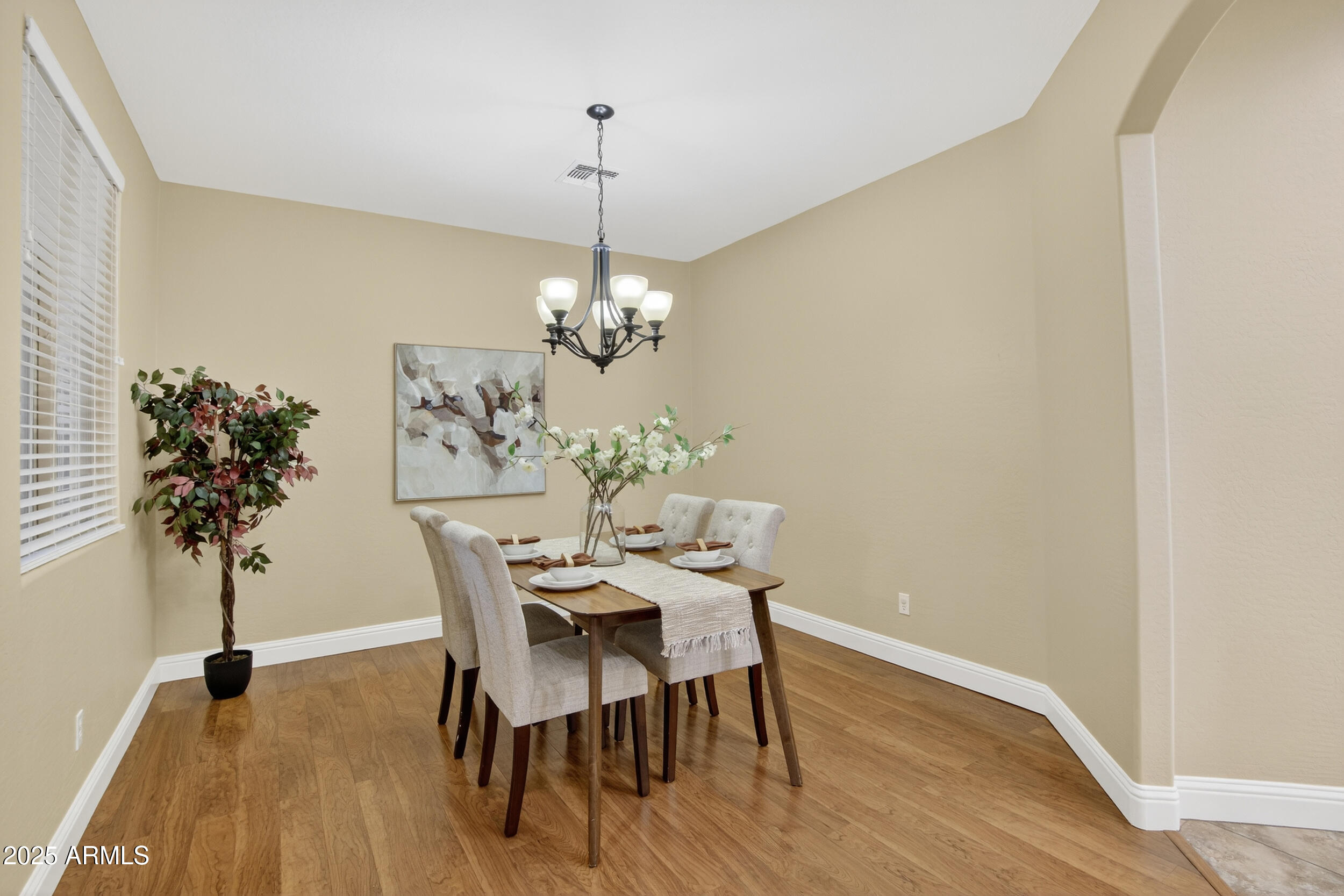 17368 West Red Bird Road Surprise, AZ 85387 - Photo 17 of 82 a view of a dining room with furniture wooden floor and chandelier