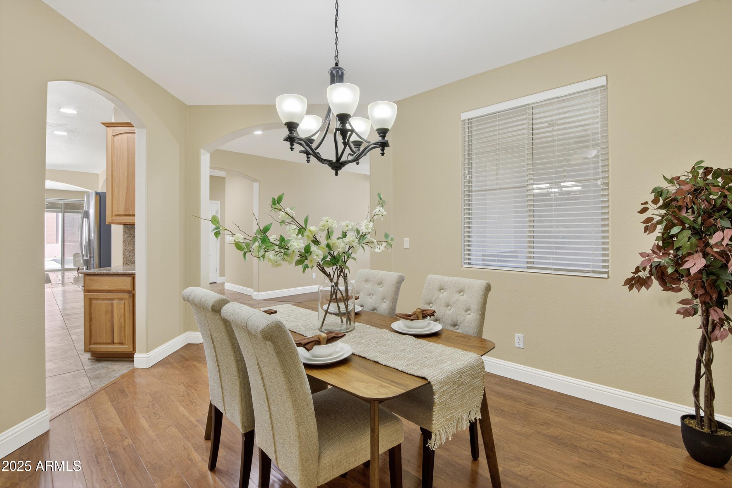 17368 West Red Bird Road Surprise, AZ 85387 - Photo 18 of 82 a dining room with furniture potted plants and wooden floor