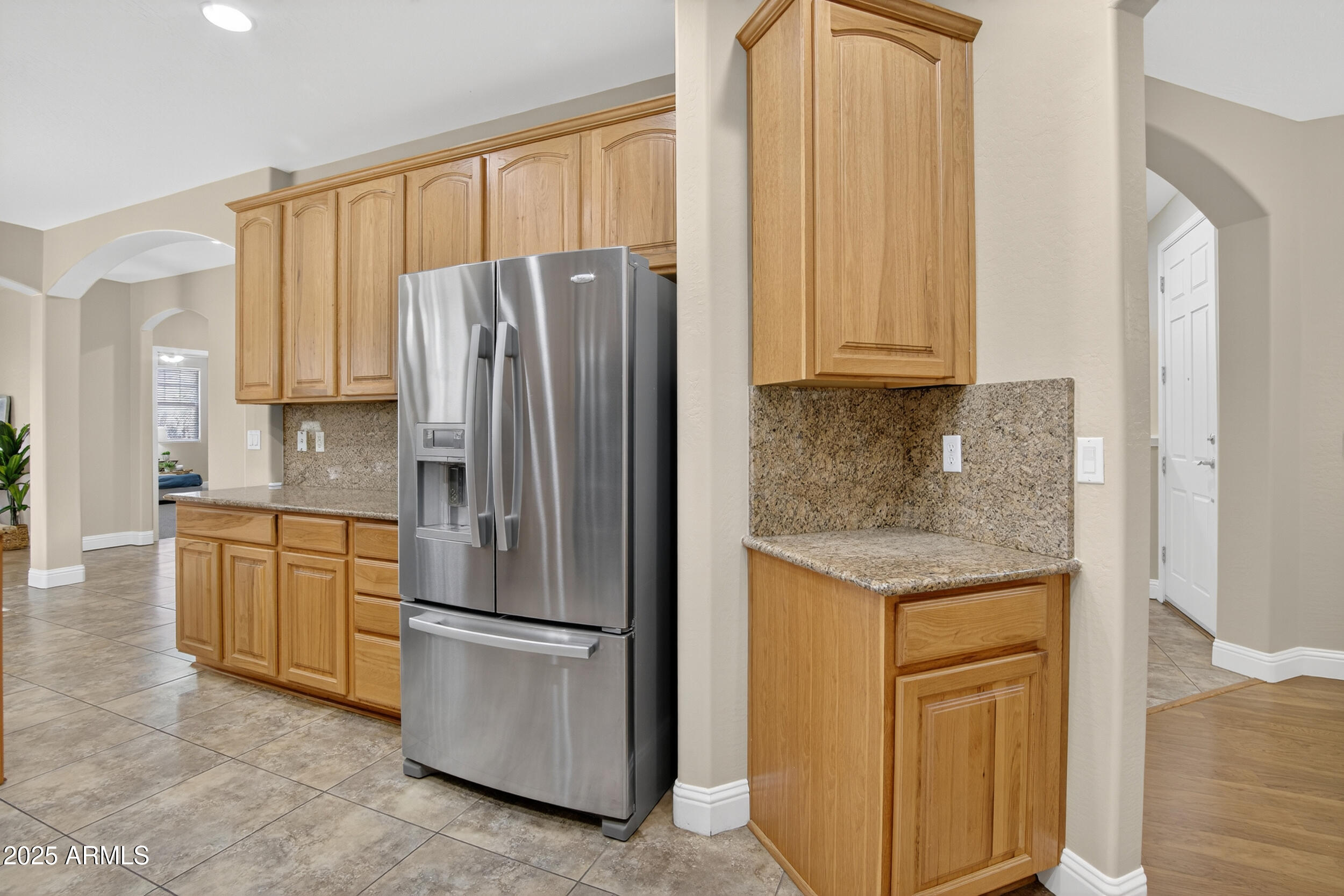 17368 West Red Bird Road Surprise, AZ 85387 - Photo 20 of 82 a kitchen with granite countertop stainless steel appliances a refrigerator and cabinets