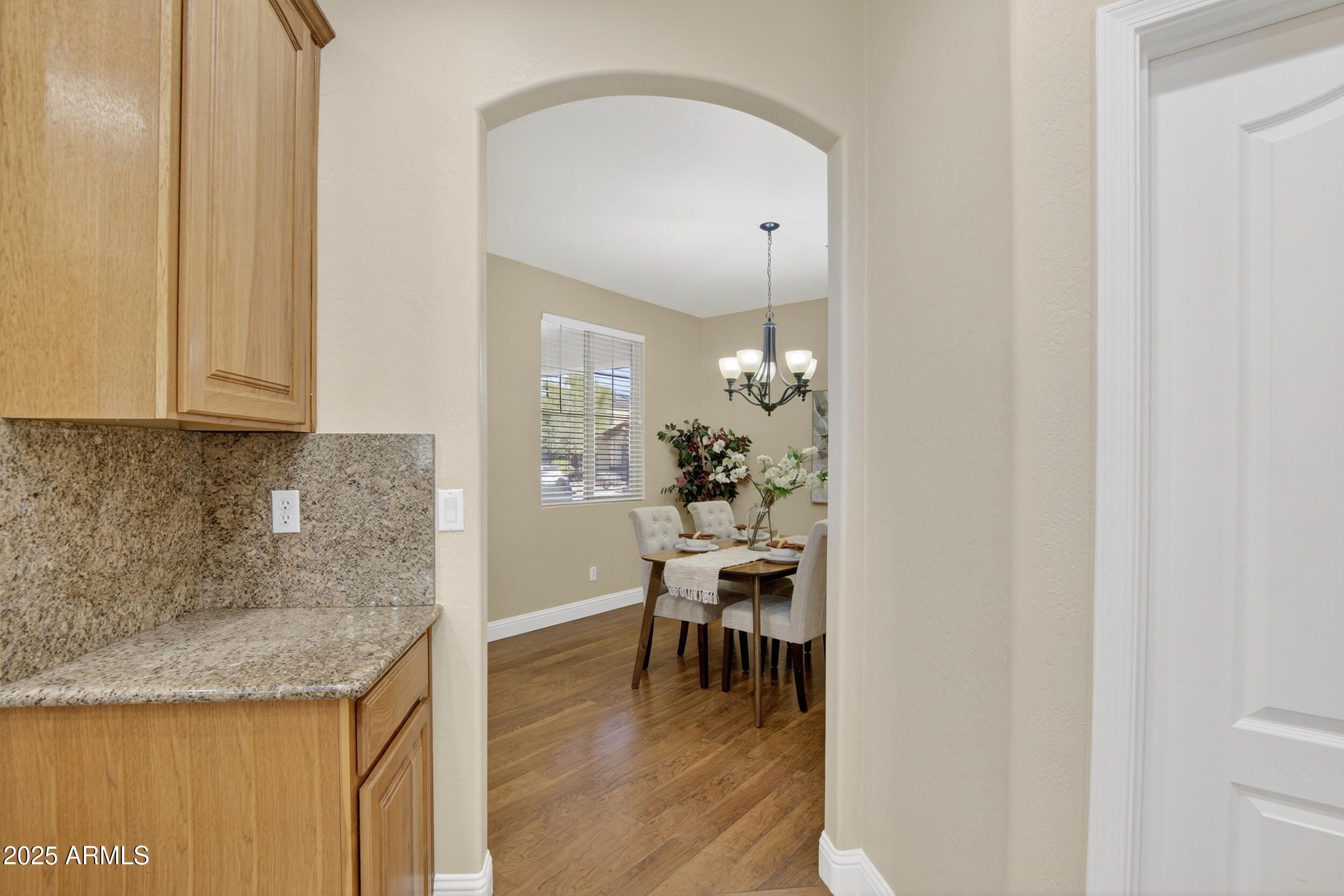 17368 West Red Bird Road Surprise, AZ 85387 - Photo 21 of 82 a kitchen with granite countertop sink and cabinets