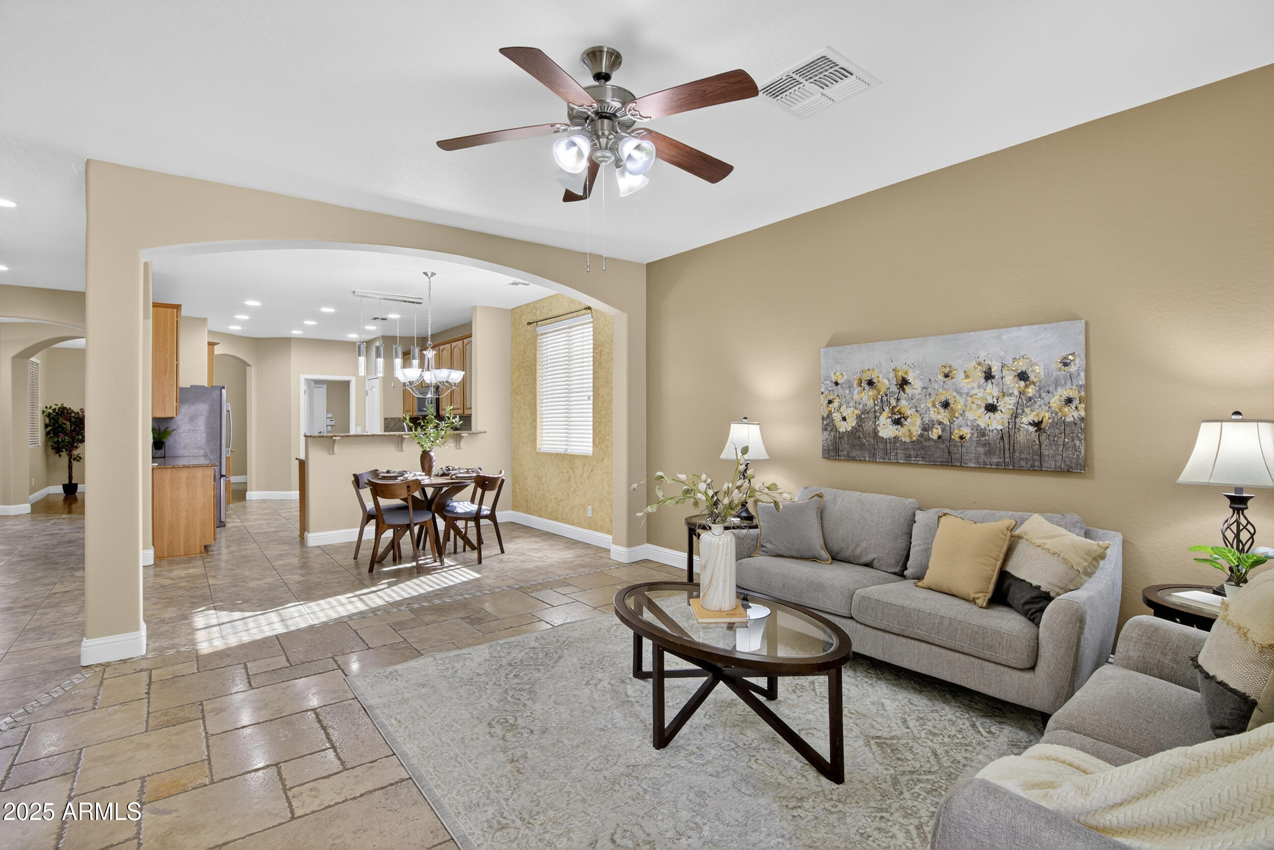17368 West Red Bird Road Surprise, AZ 85387 - Photo 27 of 82 a living room with furniture and a chandelier