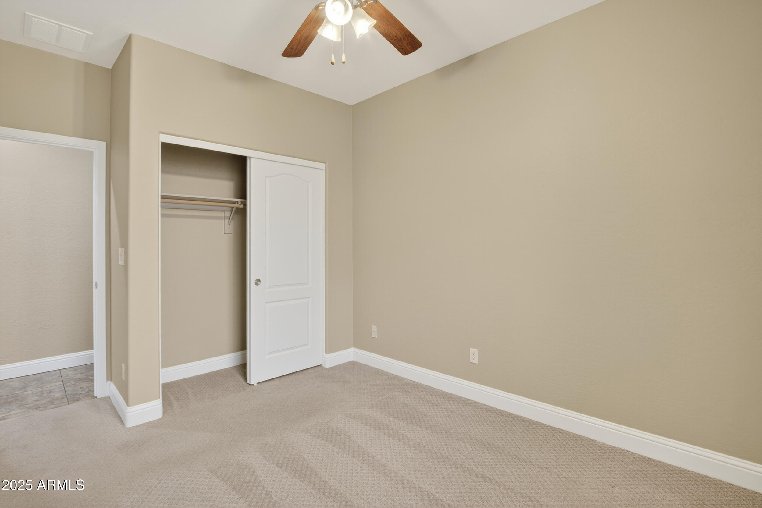 17368 West Red Bird Road Surprise, AZ 85387 - Photo 44 of 82 an empty room with a empty space and a ceiling fan