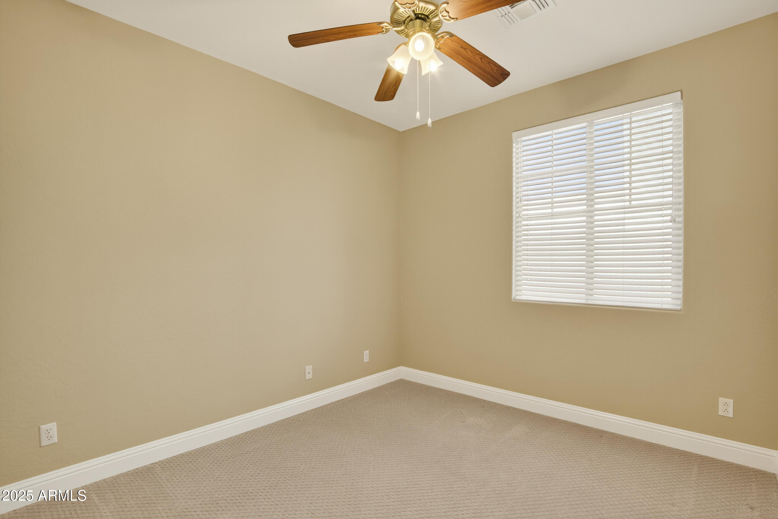 17368 West Red Bird Road Surprise, AZ 85387 - Photo 45 of 82 an empty room with a window and a fan