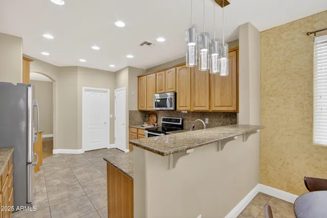 a kitchen with stainless steel appliances granite countertop a stove sink and microwave