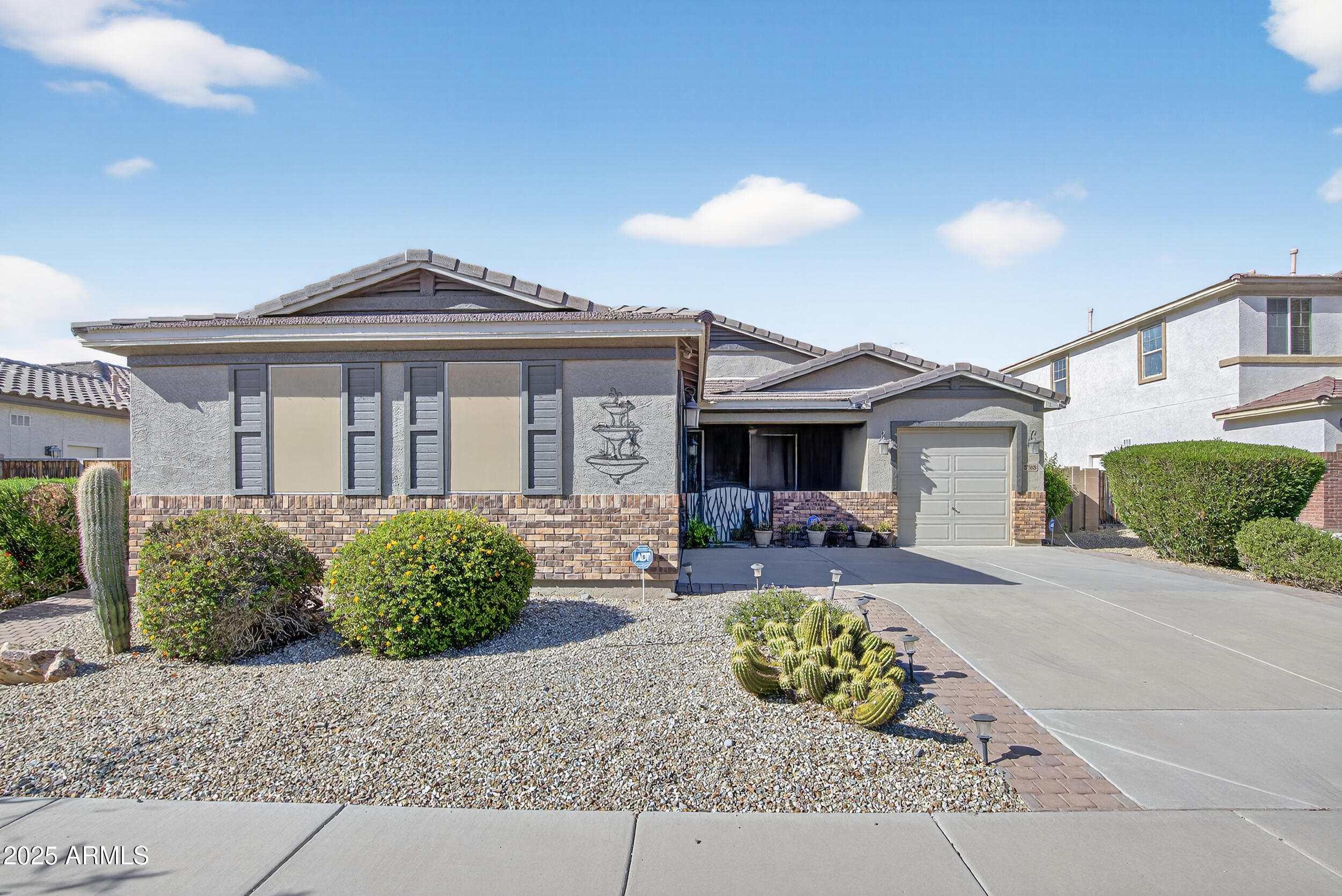 17368 West Red Bird Road Surprise, AZ 85387 - Photo 8 of 82 a front view of a house with garden
