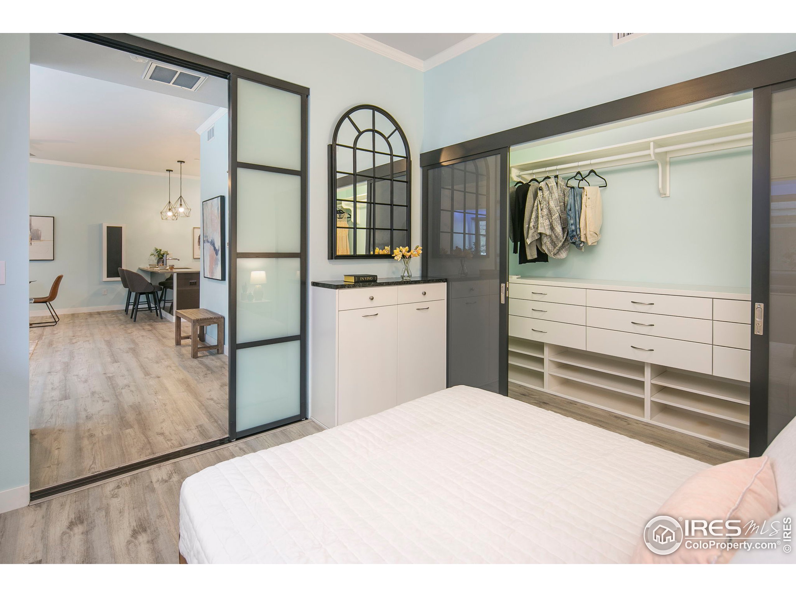 2445 Junction Place, Unit 103 Boulder, CO 80301 - Photo 14 of 29 a bedroom with a bed and wooden floor