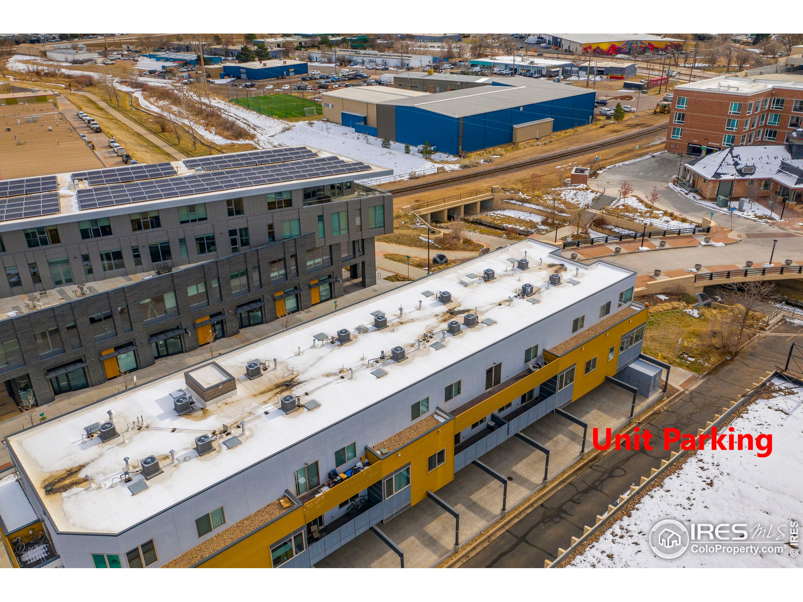 2445 Junction Place, Unit 103 Boulder, CO 80301 - Photo 24 of 29 a large building with a city skyline