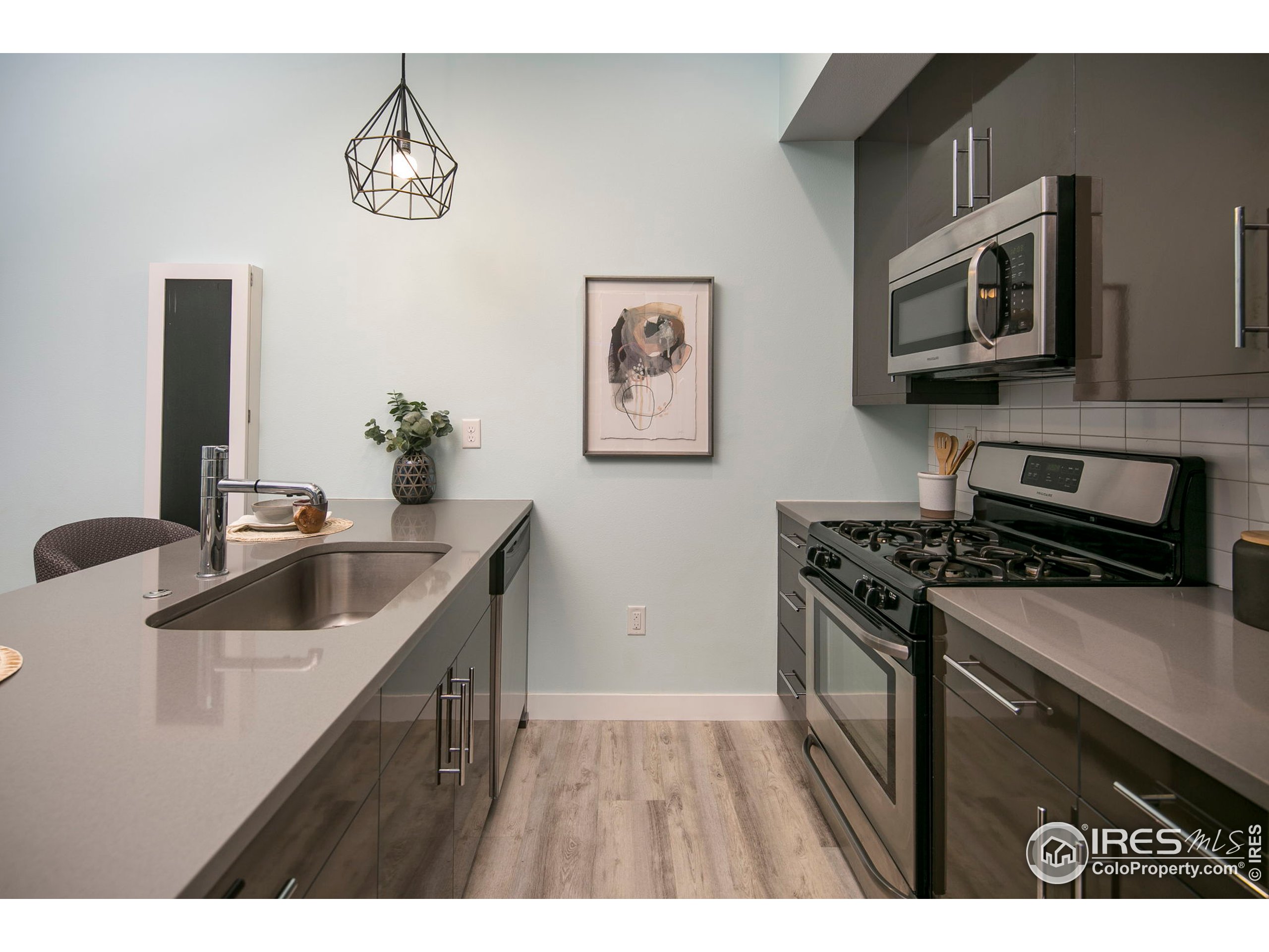 2445 Junction Place, Unit 103 Boulder, CO 80301 - Photo 6 of 29 a kitchen with stainless steel appliances granite countertop a sink stove and microwave