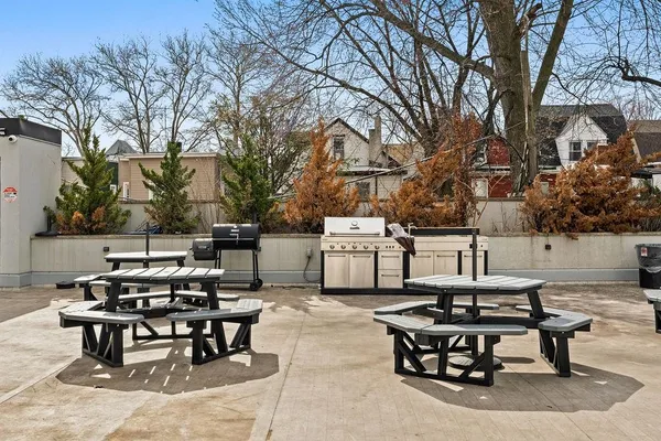 a backyard of a house with table and chairs