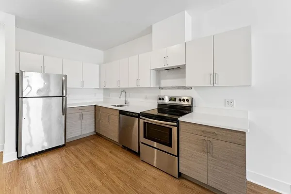 a kitchen with granite countertop white cabinets and white appliances