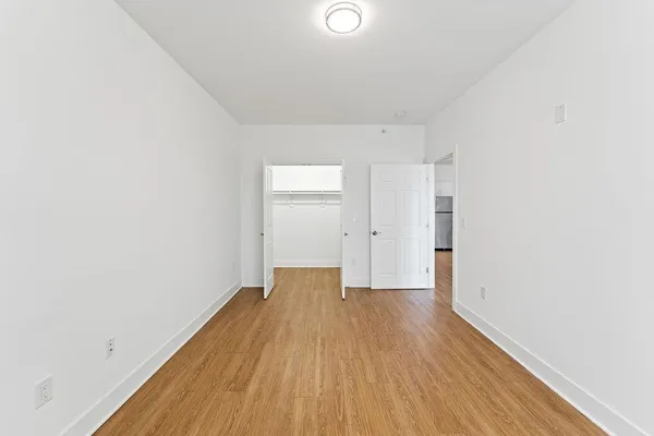 a view of an empty room with wooden floor