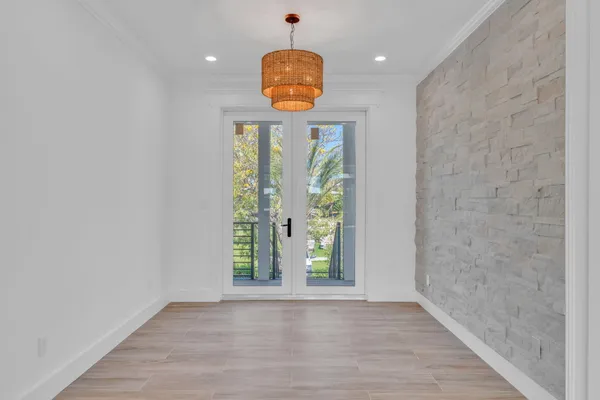 a kitchen with stainless steel appliances a stove a sink a center island and a wooden floor