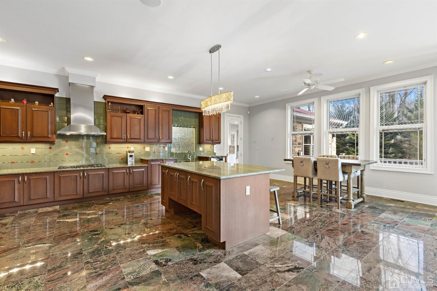 8 Madden Court Edison, NJ 08820 - Photo 15 of 75 a kitchen with stainless steel appliances granite countertop a stove top oven a sink dishwasher and a dining table with kitchen view