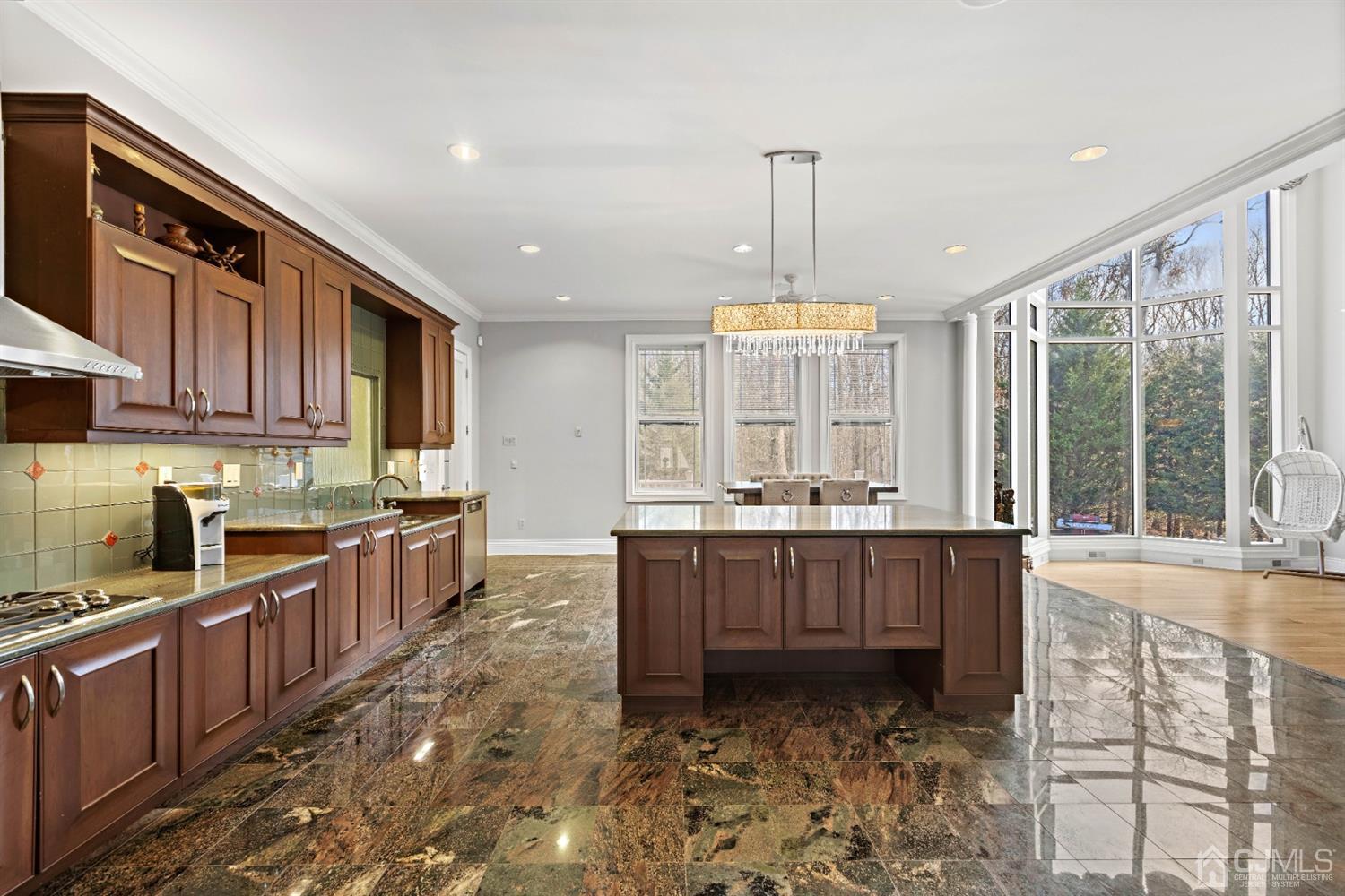 8 Madden Court Edison, NJ 08820 - Photo 21 of 75 a large kitchen with kitchen island granite countertop a stove a sink a window and wooden cabinets
