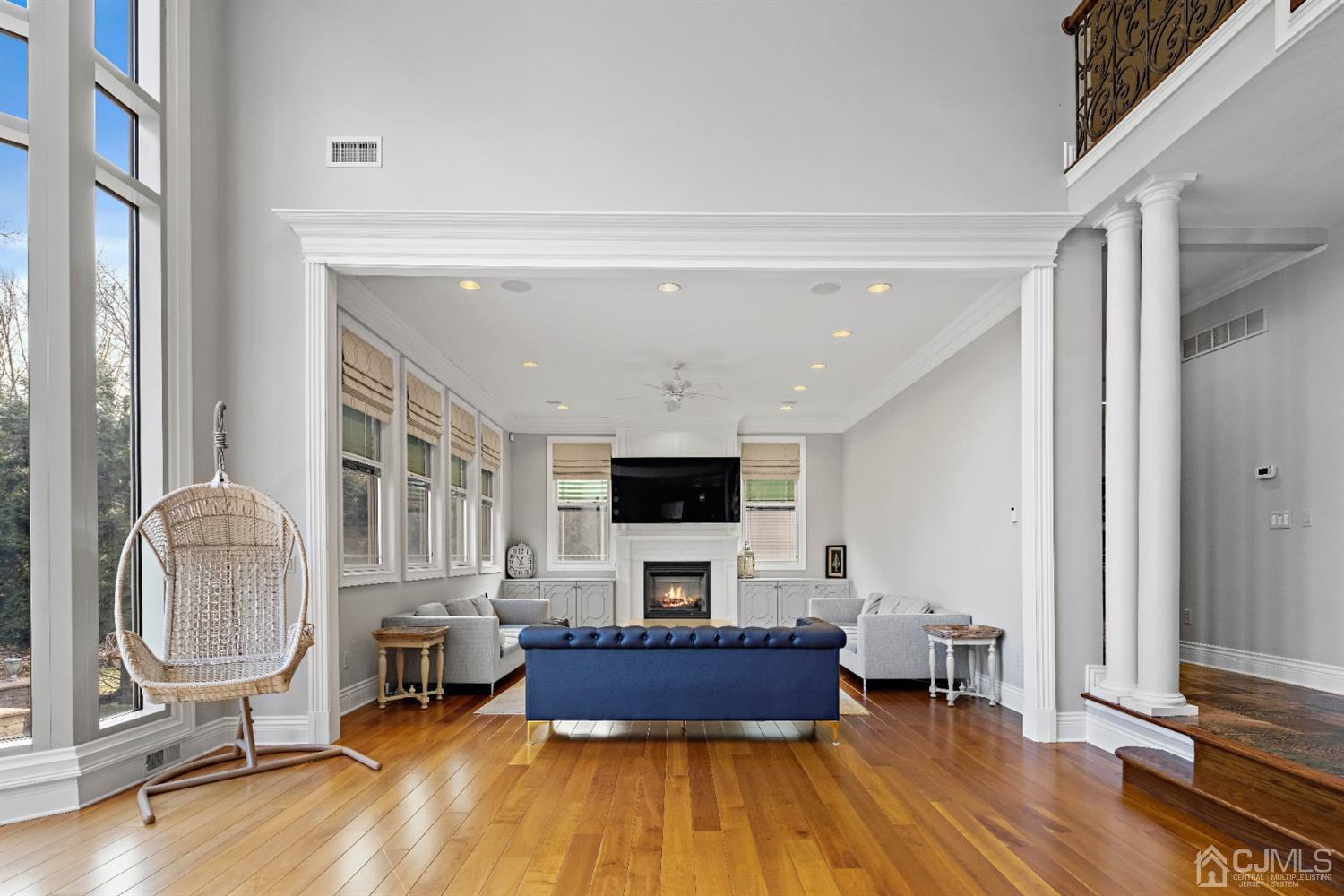 8 Madden Court Edison, NJ 08820 - Photo 26 of 75 a living room with furniture a fireplace and a flat screen tv