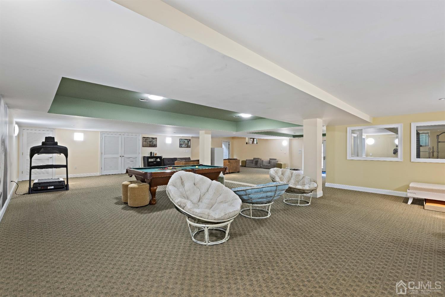 8 Madden Court Edison, NJ 08820 - Photo 47 of 75 a living room with furniture a window and gym equipment