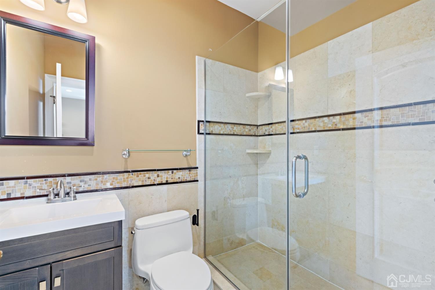 8 Madden Court Edison, NJ 08820 - Photo 51 of 75 a bathroom with a shower a sink and toilet