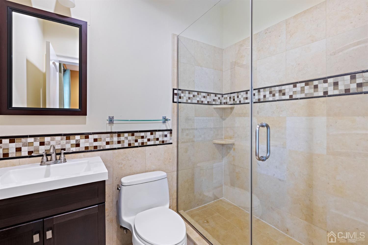 8 Madden Court Edison, NJ 08820 - Photo 53 of 75 a bathroom with a toilet a sink a mirror and a shower