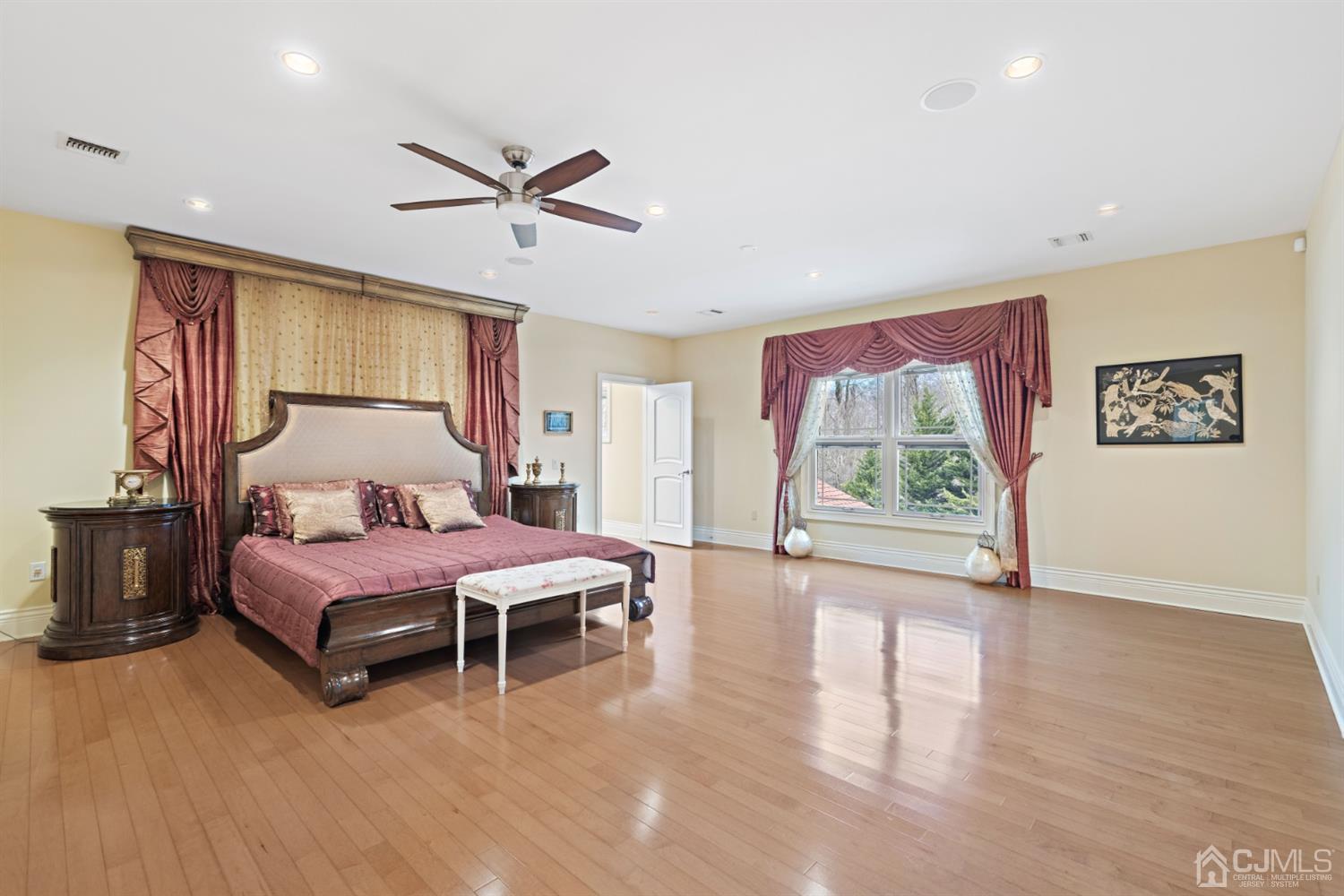 8 Madden Court Edison, NJ 08820 - Photo 58 of 75 a spacious bedroom with a bed and a large window