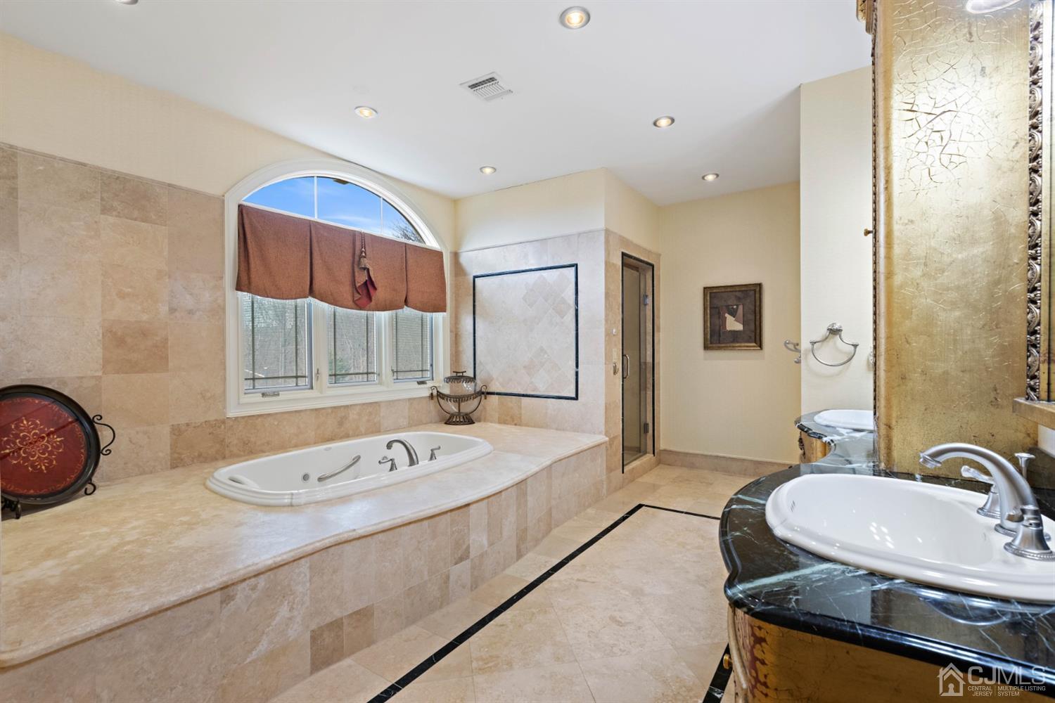 8 Madden Court Edison, NJ 08820 - Photo 62 of 75 a bathroom with a sink double vanity granite tub shower and a mirror