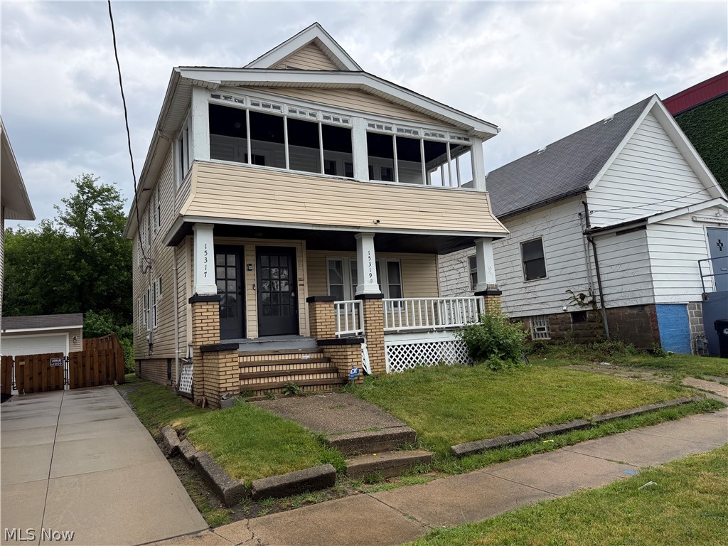 15317 Shiloh Road Cleveland, OH 44110 - Photo 2 of 29 Two-story structure with light-toned siding and a prominent porch
