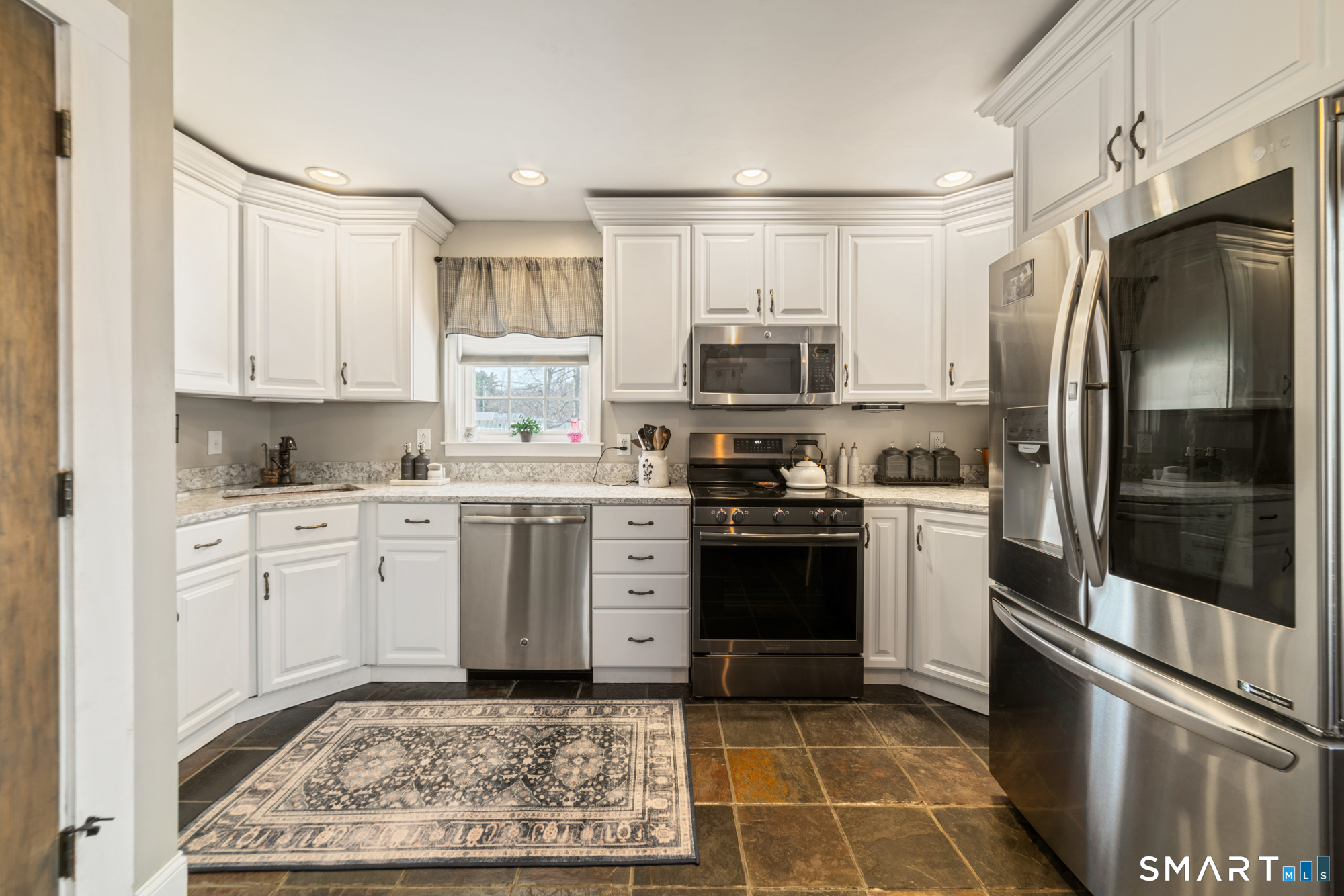 101 Vincent Road Bristol, CT 06010 - Photo 14 of 37 a kitchen with a sink stainless steel appliances and cabinets
