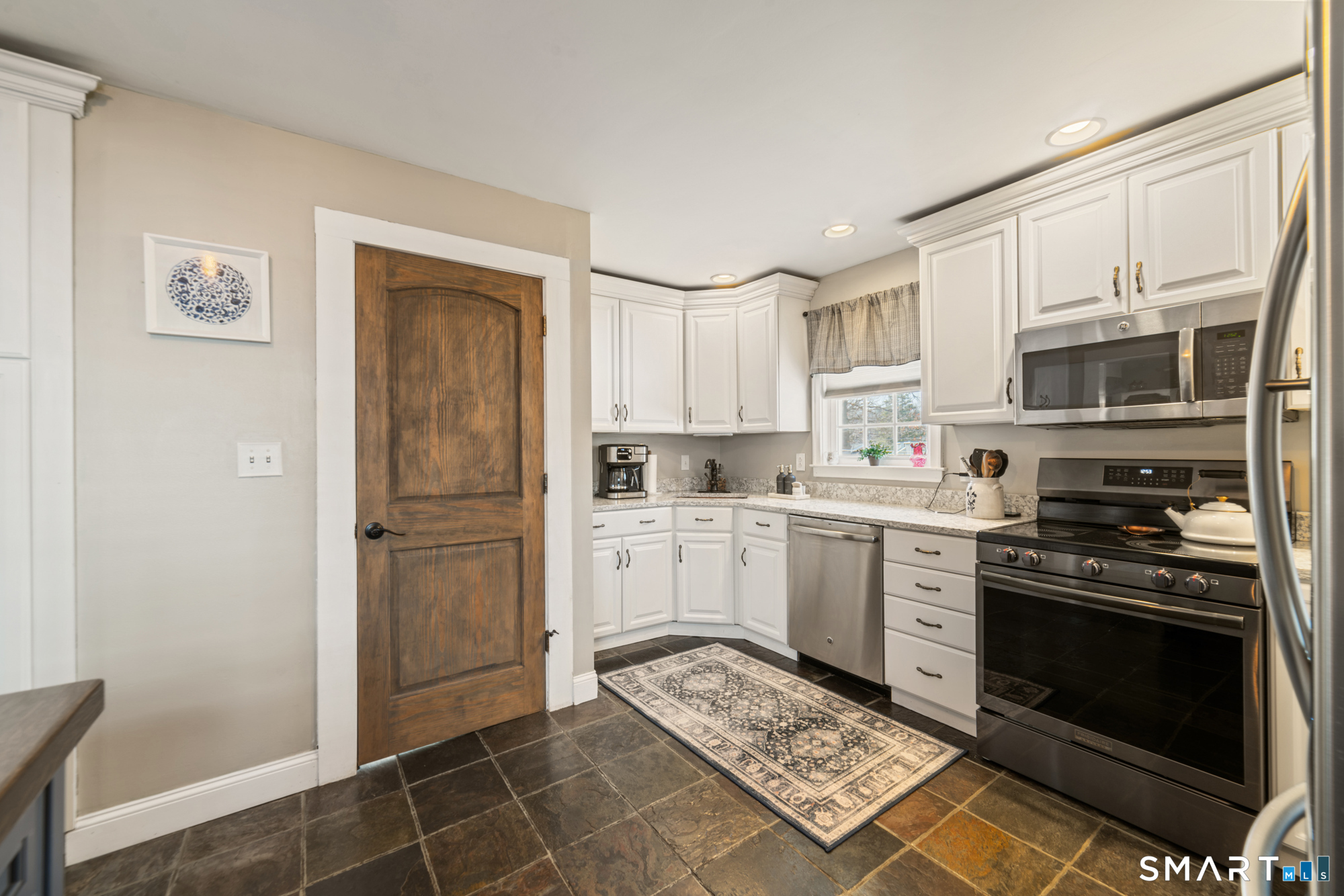 101 Vincent Road Bristol, CT 06010 - Photo 18 of 37 a kitchen with stainless steel appliances granite countertop a refrigerator stove and sink
