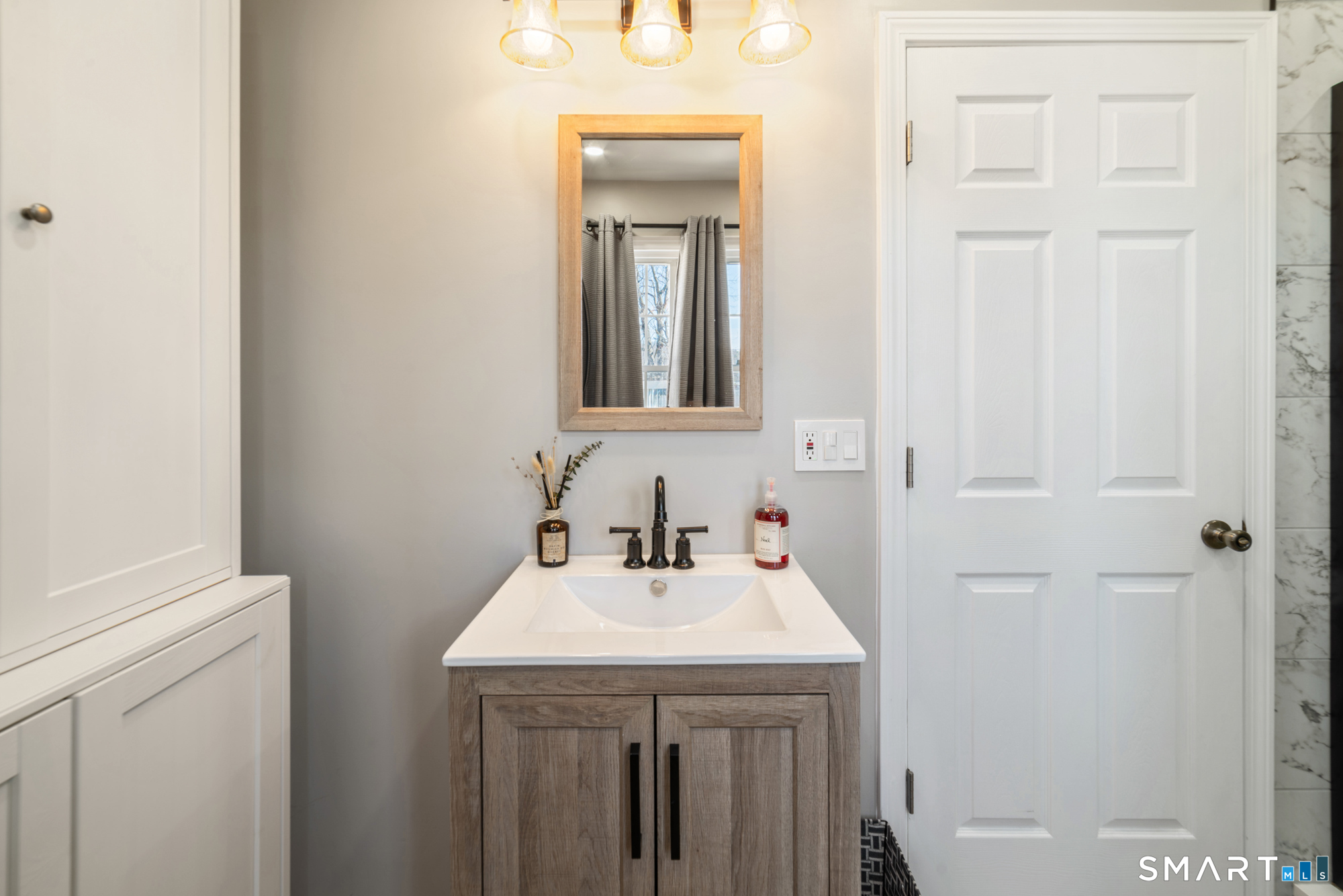101 Vincent Road Bristol, CT 06010 - Photo 20 of 37 a bathroom with a sink and a mirror