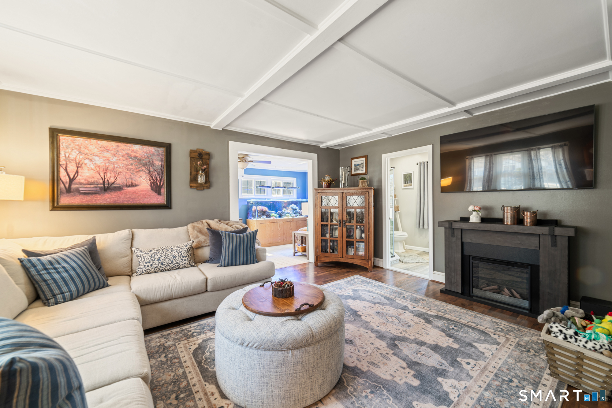 101 Vincent Road Bristol, CT 06010 - Photo 8 of 37 a living room with furniture a flat screen tv and a fireplace