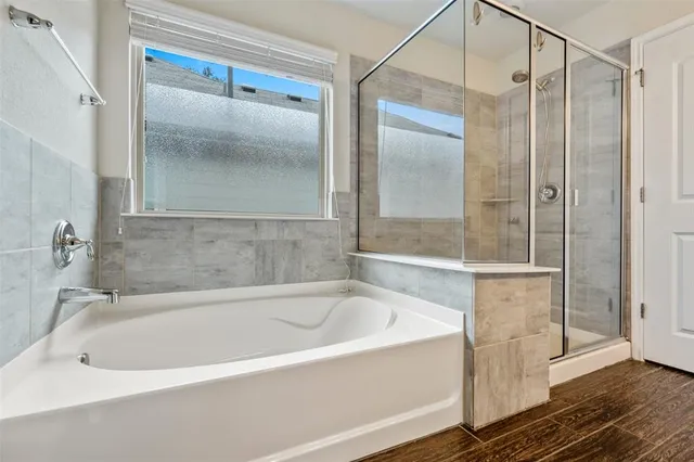 a white bath tub sitting next to a shower