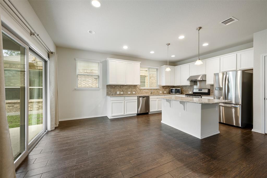 10612 Turnbull Loop, Unit 30 Austin, TX 78717 - Photo 7 of 30 a kitchen with a refrigerator and white cabinets