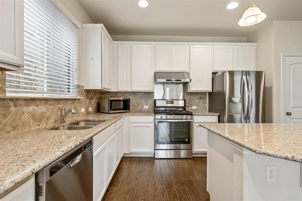 10612 Turnbull Loop, Unit 30 Austin, TX 78717 - Photo 9 of 30 a kitchen with stainless steel appliances granite countertop a sink stove and refrigerator
