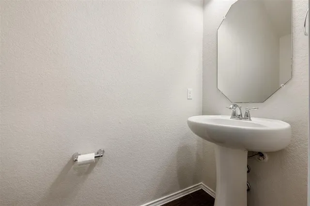 a bathroom with a sink and mirror