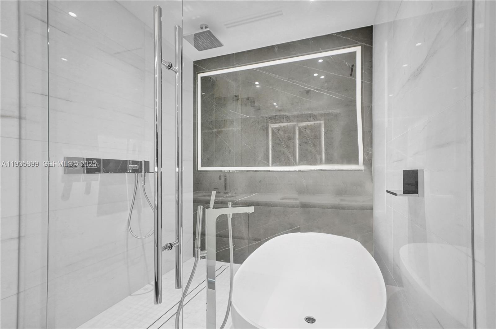 300 Biscayne Blvd Way, Unit 3605W Miami, FL 33131 - Photo 40 of 65 a bathroom with a sink and a mirror