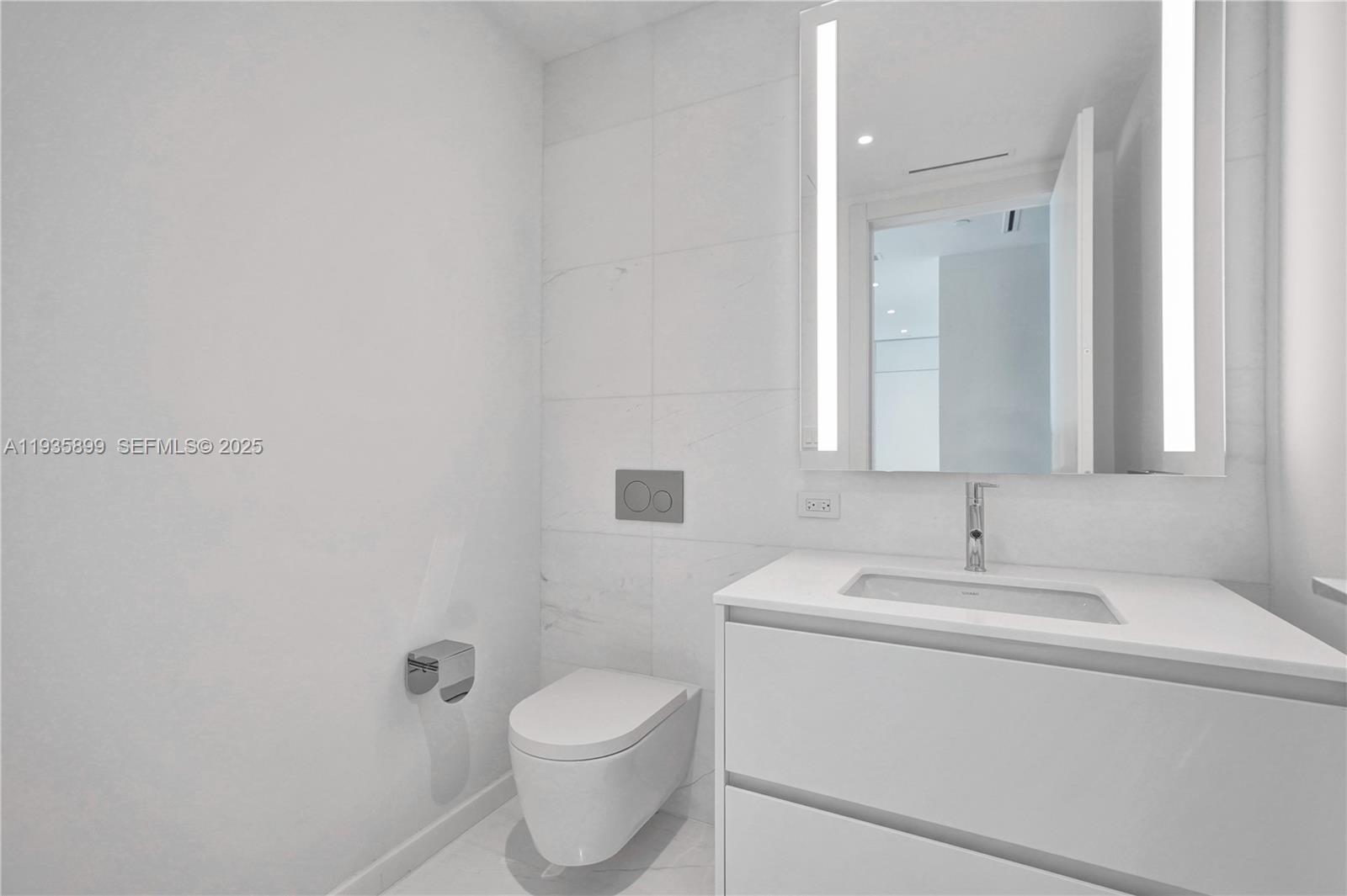 300 Biscayne Blvd Way, Unit 3605W Miami, FL 33131 - Photo 42 of 65 a bathroom with a toilet sink and mirror