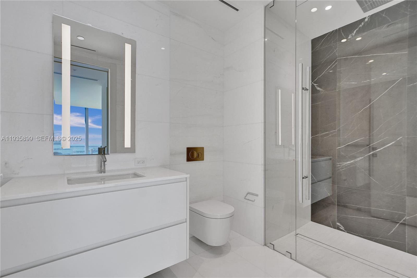300 Biscayne Blvd Way, Unit 3605W Miami, FL 33131 - Photo 50 of 65 a bathroom with a bathtub shower sink mirror and toilet