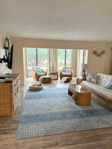 a living room with furniture and a floor to ceiling window