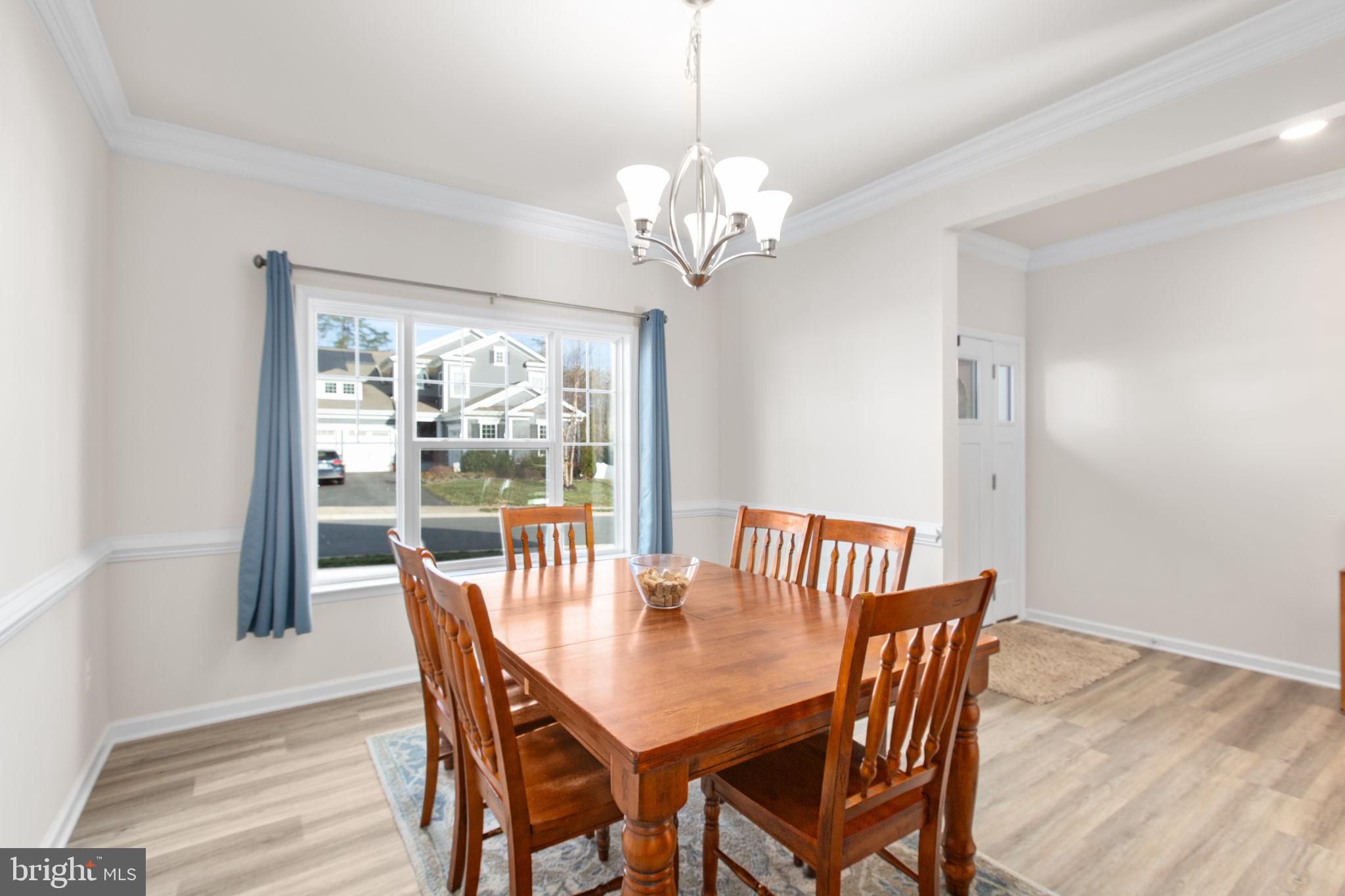 8 Shermans Ridge Road Stafford, VA 22554 - Photo 12 of 37 a view of a dining room with furniture a chandelier and wooden floor