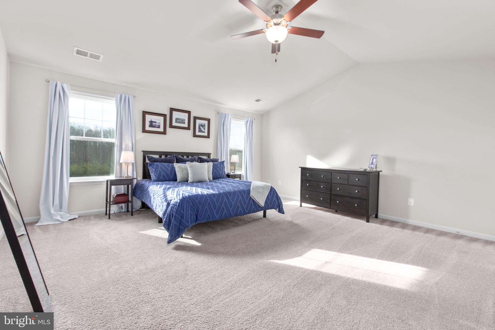 8 Shermans Ridge Road Stafford, VA 22554 - Photo 19 of 37 a spacious bedroom with a bed and a chandelier