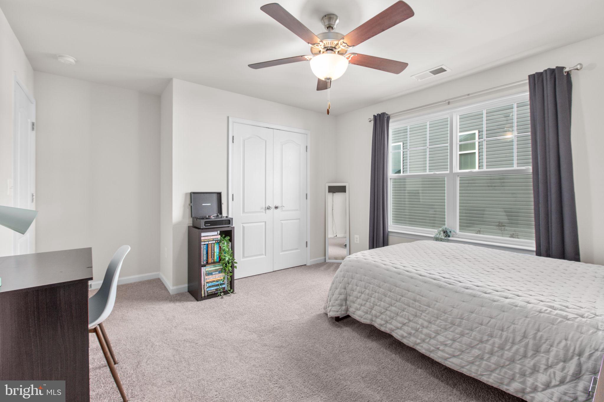 8 Shermans Ridge Road Stafford, VA 22554 - Photo 23 of 37 a bedroom with a large bed and a chandelier
