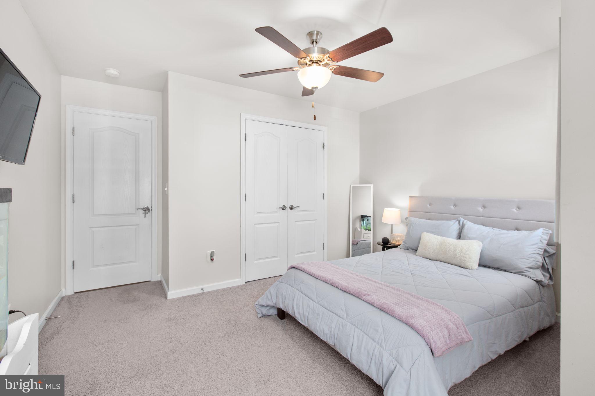 8 Shermans Ridge Road Stafford, VA 22554 - Photo 24 of 37 a bedroom with a large bed and a ceiling fan