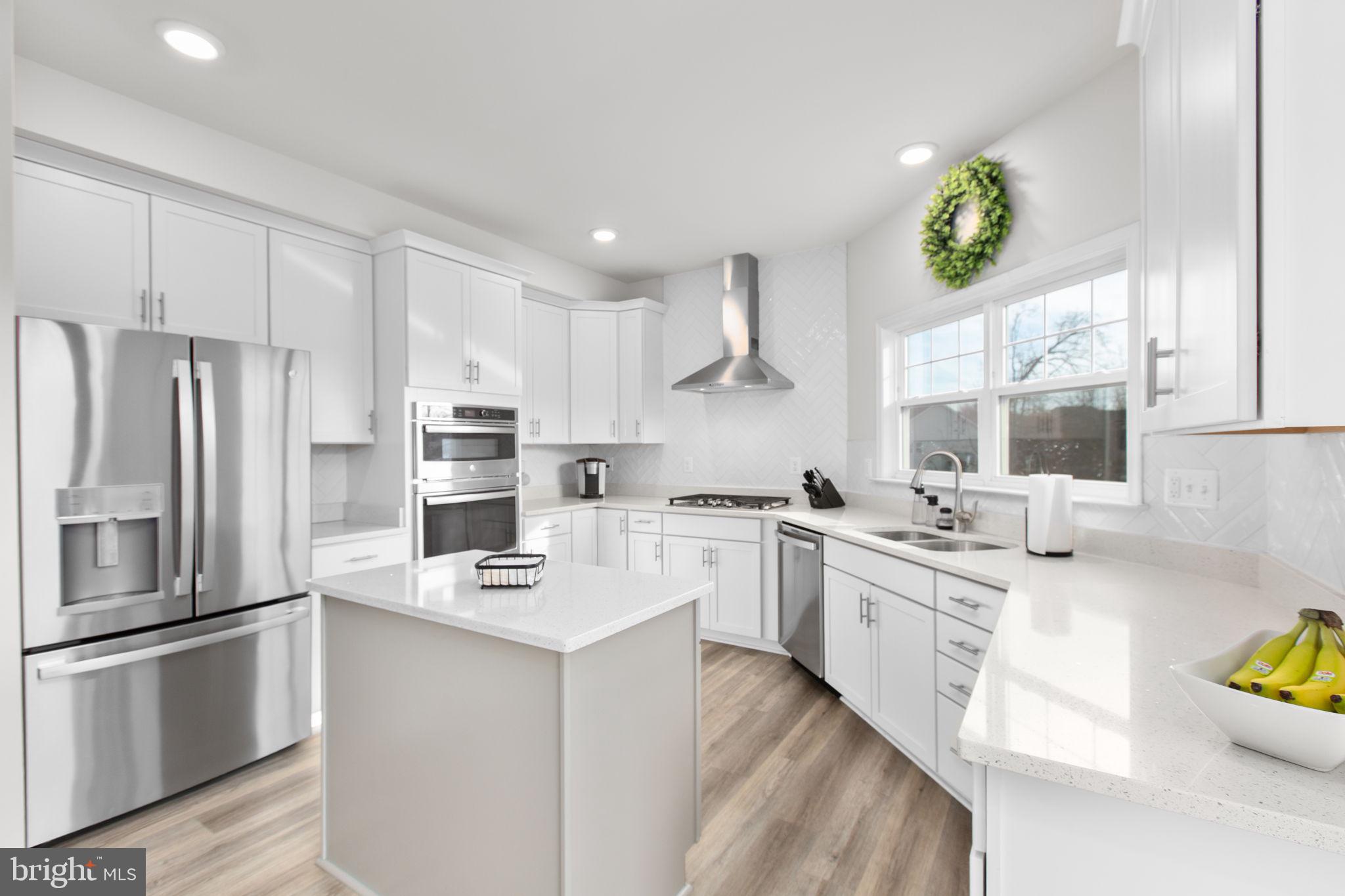 8 Shermans Ridge Road Stafford, VA 22554 - Photo 6 of 37 a kitchen with stainless steel appliances granite countertop a refrigerator sink and white cabinets