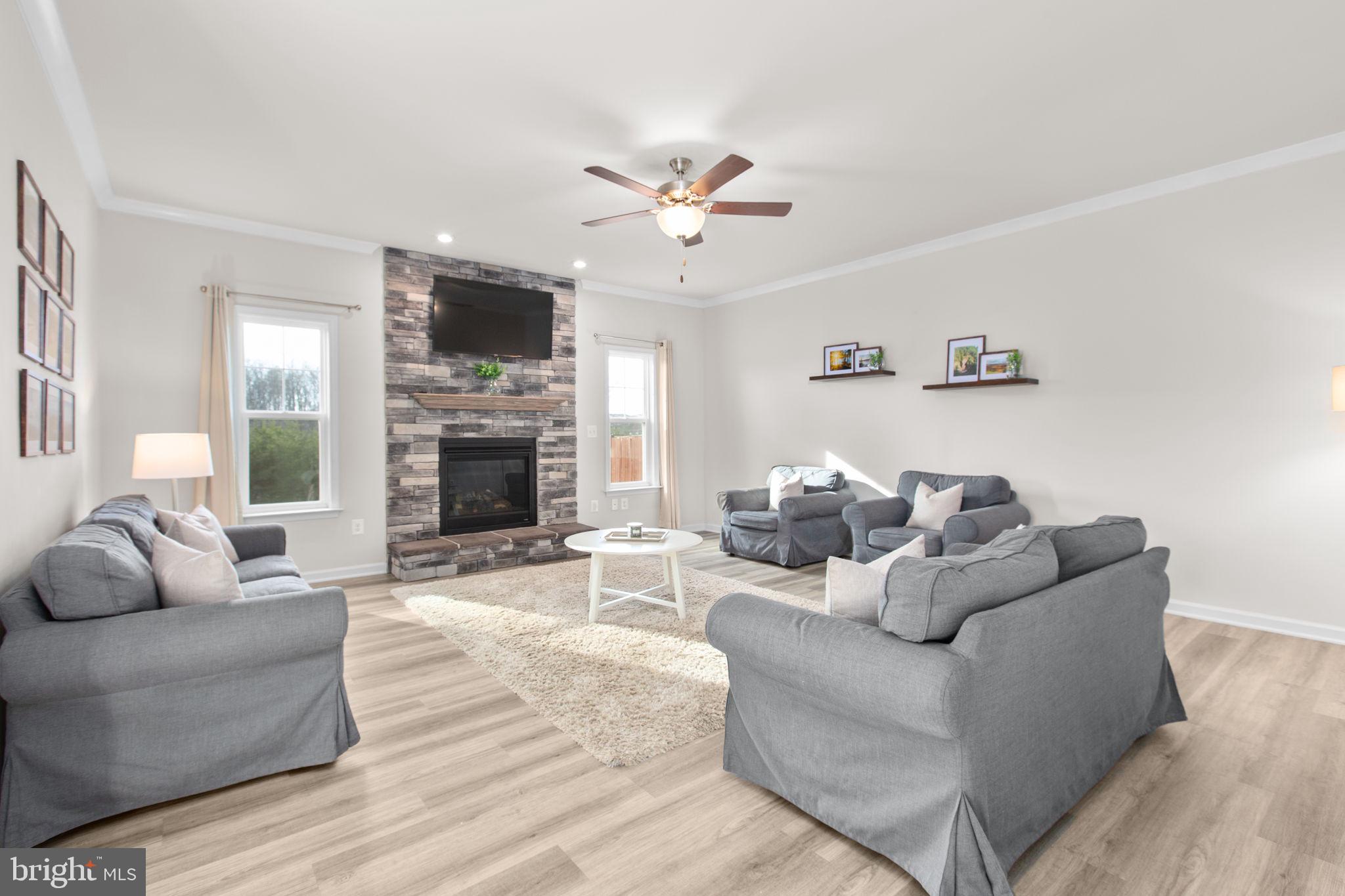 8 Shermans Ridge Road Stafford, VA 22554 - Photo 9 of 37 a living room with furniture a flat screen tv and a fireplace