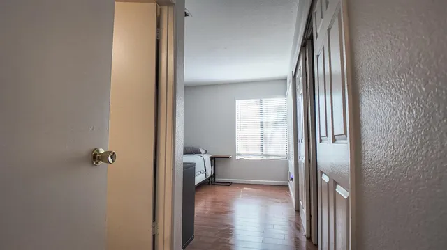 a view of bedroom with a bed and wooden floor