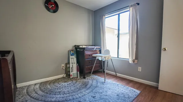 a view of room with window and wooden floor