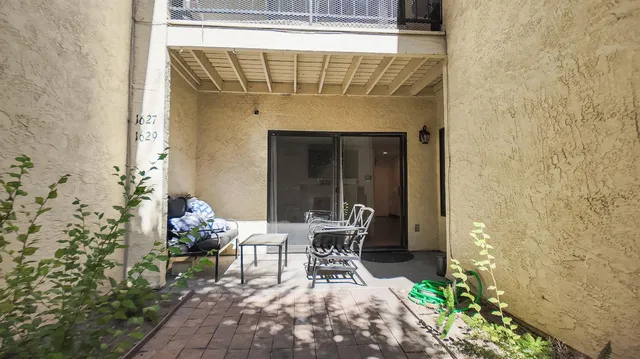 a view of empty room with wooden floor and fireplace
