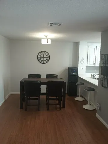 a view of a workspace with furniture and wooden floor
