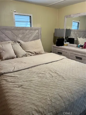 a bedroom with a bed and a view of bedroom