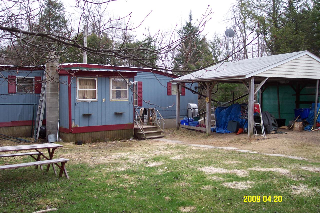 48 East Windsor Road Peru, MA 01235 - Photo 1 of 4 a view of a barn in the middle of a yard