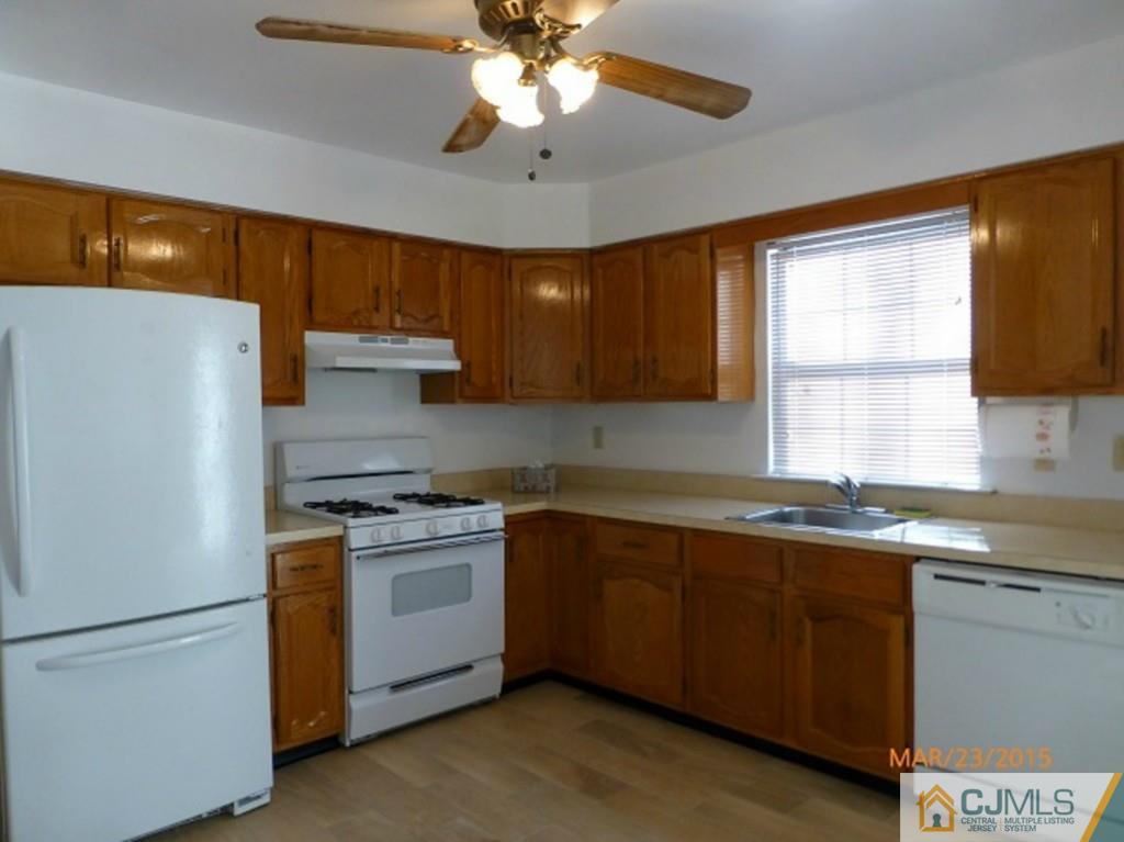 1603 Timber Oaks Road Edison, NJ 08820 - Photo 3 of 17 a kitchen with a stove a sink and a refrigerator